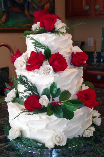 Christmas wedding cake with white and red roses